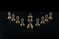 Chess king with a retinue of pawns on a black background. Royalty Free Stock Photo