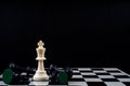 Chess king standing wins the game of chess setup on dark background. Chess concept save the king and save the strategy, game over Royalty Free Stock Photo