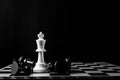 Chess king standing wins the game of chess setup on dark background. Chess concept save the king and save the strategy, game over Royalty Free Stock Photo