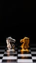 Chess knights face-off. Silver and gold chessmen on chesboard Royalty Free Stock Photo