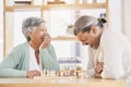Chess, laugh and senior couple play games for relaxing, bonding and spending time together at home. Marriage, retirement Royalty Free Stock Photo