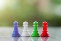 Chess pawn against blurred natural green background