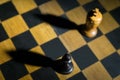 Chess pawn casting a king piece shadow on chessboard concept of strength Royalty Free Stock Photo