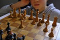 Chess piece across chess board and person thinking of a next move close-up. Playing chess. Strategy, planning concept
