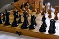 Chess piece across chess board and person thinking of a next move close-up. Playing chess. Strategy, planning concept