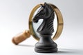 Chess Piece with Magnifying Glass on Gray Background, Symbolizing Strategy and Focus Royalty Free Stock Photo