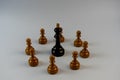 Chess pieces, black king surrounded by white pawns Royalty Free Stock Photo