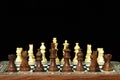 Chess pieces and board on black Royalty Free Stock Photo