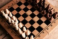 Chess pieces and chessboard on a wooden table Royalty Free Stock Photo