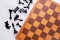 Chess pieces and game board on wooden background. Royalty Free Stock Photo