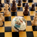 Chess pieces and globe Royalty Free Stock Photo