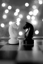 Chess pieces, horse, white and black on a chessboard, concept of leadership and teamwork in business, duel, opposition of light