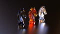 Chess 3 pieces horses made of glass colors red, blue, transparent. Royalty Free Stock Photo