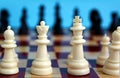 Chess pieces are placed on a checkered board for starting a game Royalty Free Stock Photo