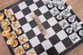 Chess pieces placed on the chessboard and the dollar coin in the middle Royalty Free Stock Photo