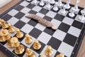 Chess pieces placed on the chessboard and the dollar coin in the middle Royalty Free Stock Photo