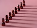 chess pieces in a row, pawns on a pink background, Royalty Free Stock Photo