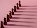 chess pieces in a row, pawns on a pink background, Royalty Free Stock Photo