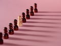 chess pieces in a row, pawns on a pink background, team concept Royalty Free Stock Photo