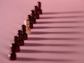 chess pieces in a row, pawns on a pink background, team concept Royalty Free Stock Photo