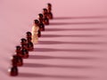 chess pieces in a row, pawns on a pink background, team concept Royalty Free Stock Photo