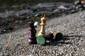 Chess pieces on the sand by the river