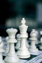 Chess pieces on a board blurred black background