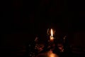 Chess pieces stand on a chessboard and clock and next to a burning candle in the dark, playing Royalty Free Stock Photo