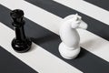 Chess pieces on a striped surface. the stripes are black and white. knight and queen