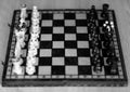 Chess pieces on wooden game board. Royalty Free Stock Photo