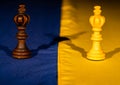 Chess pieces on the yellow blue flag of ukraine. The concept of russian Ukrainian war, escalation, military conflict Royalty Free Stock Photo