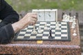 Chess player in the park. Old man plays chess in the park Royalty Free Stock Photo