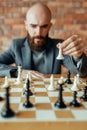 Chess player playing white figures, queen move