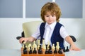 Chess player, smart boy. Logical thinking. Quarantine Games. Chess. Boy puts pieces on a chessboard. Training the mind Royalty Free Stock Photo