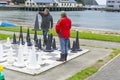 Chess players on oversized outdoor board and set