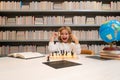 Chess school. Concentrated child play chess. Smart child play chess in the library by the bookshelves. Educational Royalty Free Stock Photo