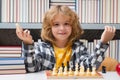 Chess school for kids. Kid thinking about chess. The concept of learning and growing children. Chess, success and Royalty Free Stock Photo