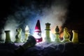 Chess in the snow. winter concept. Christmas or New Year present on a chessboard with Santa Claus on a dark background. Copy space