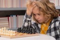 Chess, success and winning. Kid thinking about chess. The concept of learning and growing children. Chess, success and Royalty Free Stock Photo