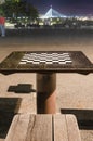Chess table in the park in the night, big bridge in a distance Royalty Free Stock Photo