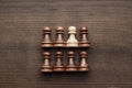 Chess uniqueness concept on wooden background