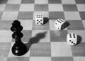 Chessboard with black king and three dices Royalty Free Stock Photo