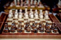 Chessboard with chess on a wooden bench.