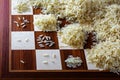 Chessboard with expotential growing heaps of rice grains, concep