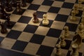 A chessboard with figures, the concept of the confrontation of different forces, or a complex business