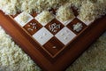 Chessboard with growing heaps of rice grains, view from above sh