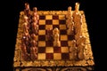 Chessboard with Queen Gambit opening on black background, carved chess Royalty Free Stock Photo
