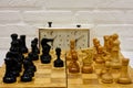 Chessboard with the Queen Gambit opening and a clock showing the time of the game Royalty Free Stock Photo