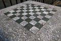 chessboard on a stone table in a public park (brooklyn new york city) chess board checkered squares Royalty Free Stock Photo