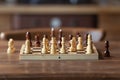 Chessboard on table in game process. Board with chess pieces Royalty Free Stock Photo